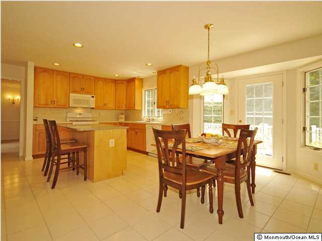 4 Seaman Road Freehold, NJ 07728 - Photo 5 of 13 a dining area with stainless steel appliances kitchen island granite countertop a table and chairs