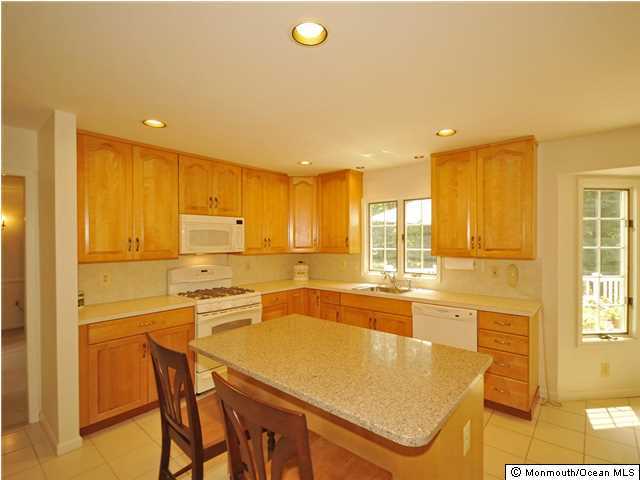 4 Seaman Road Freehold, NJ 07728 - Photo 6 of 13 a kitchen with stainless steel appliances granite countertop a granite counter tops and a refrigerator