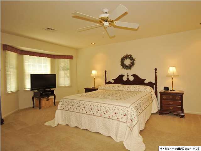 4 Seaman Road Freehold, NJ 07728 - Photo 9 of 13 a spacious bedroom with a bed and a flat screen tv