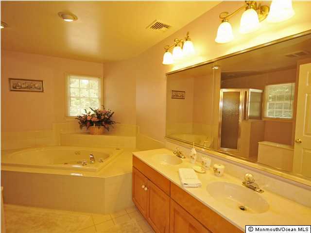 4 Seaman Road Freehold, NJ 07728 - Photo 10 of 13 a bathroom with a tub sink and mirror