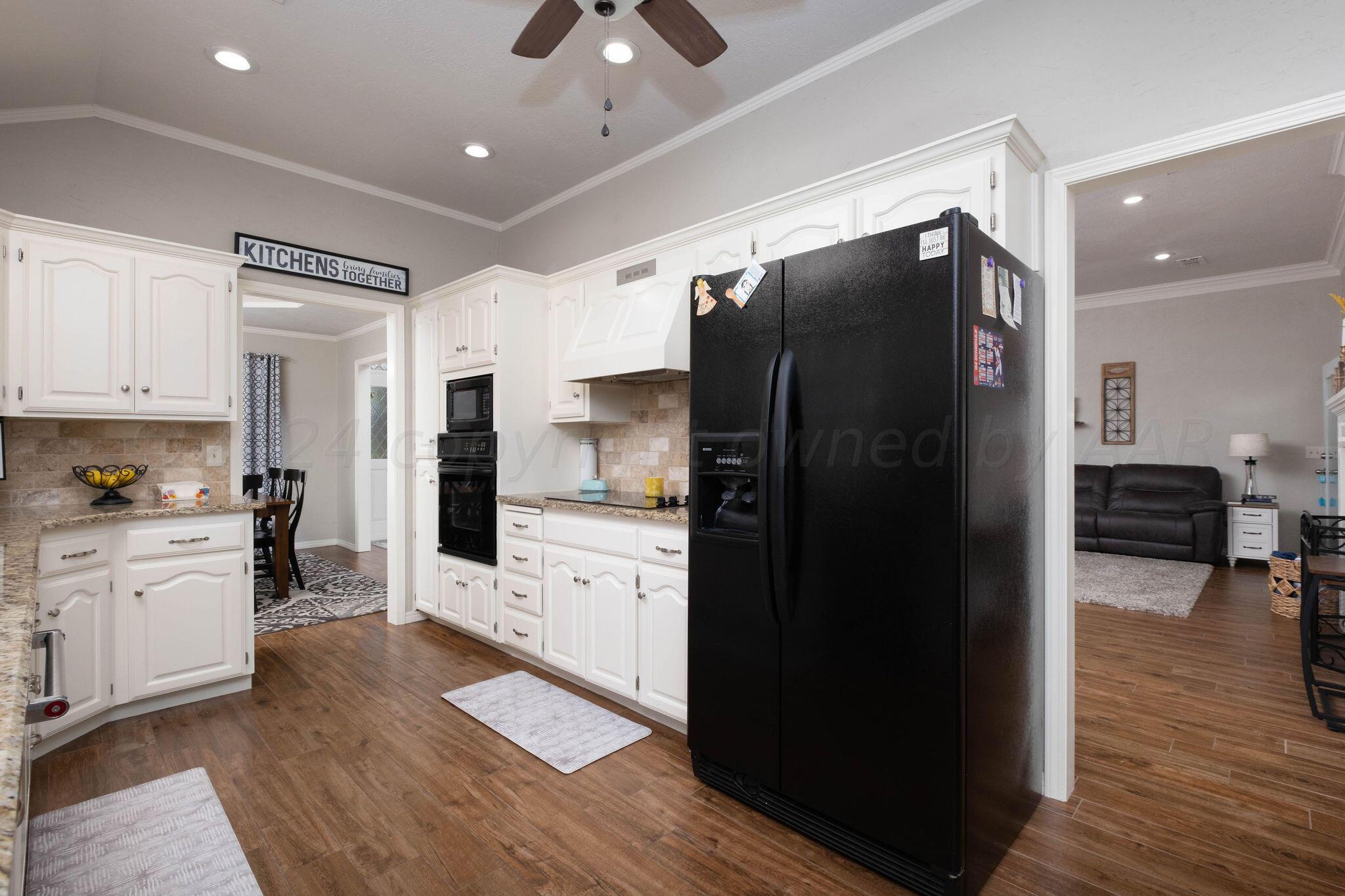 4400 Baltus Place Amarillo, TX 79121 - Photo 14 of 39 a kitchen with a refrigerator and a sink