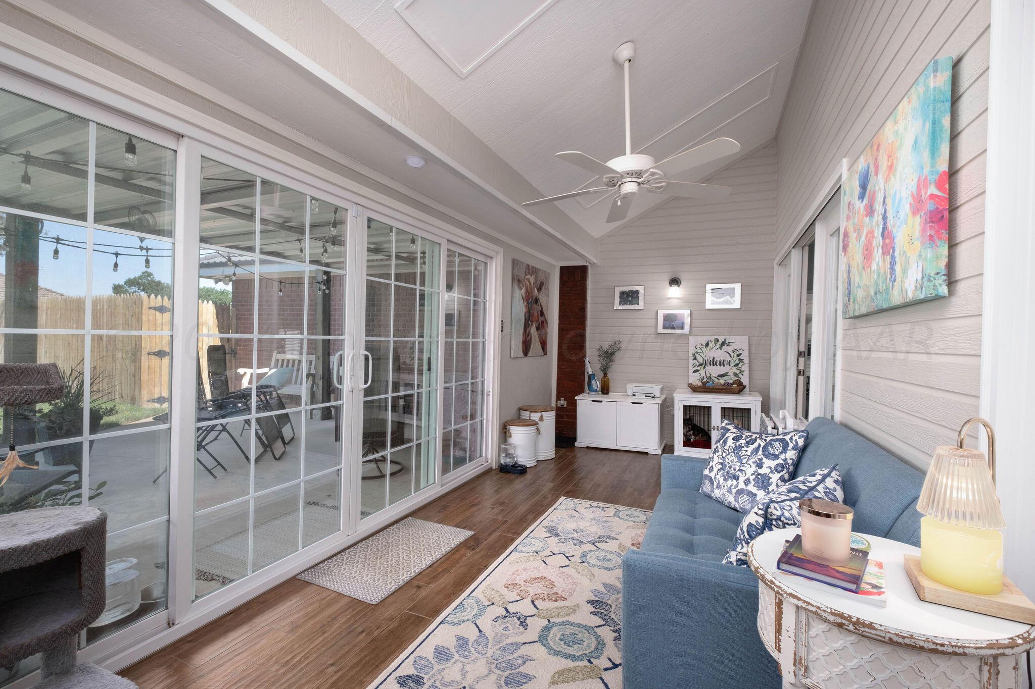 4400 Baltus Place Amarillo, TX 79121 - Photo 18 of 39 a living room with furniture a fireplace and a chandelier