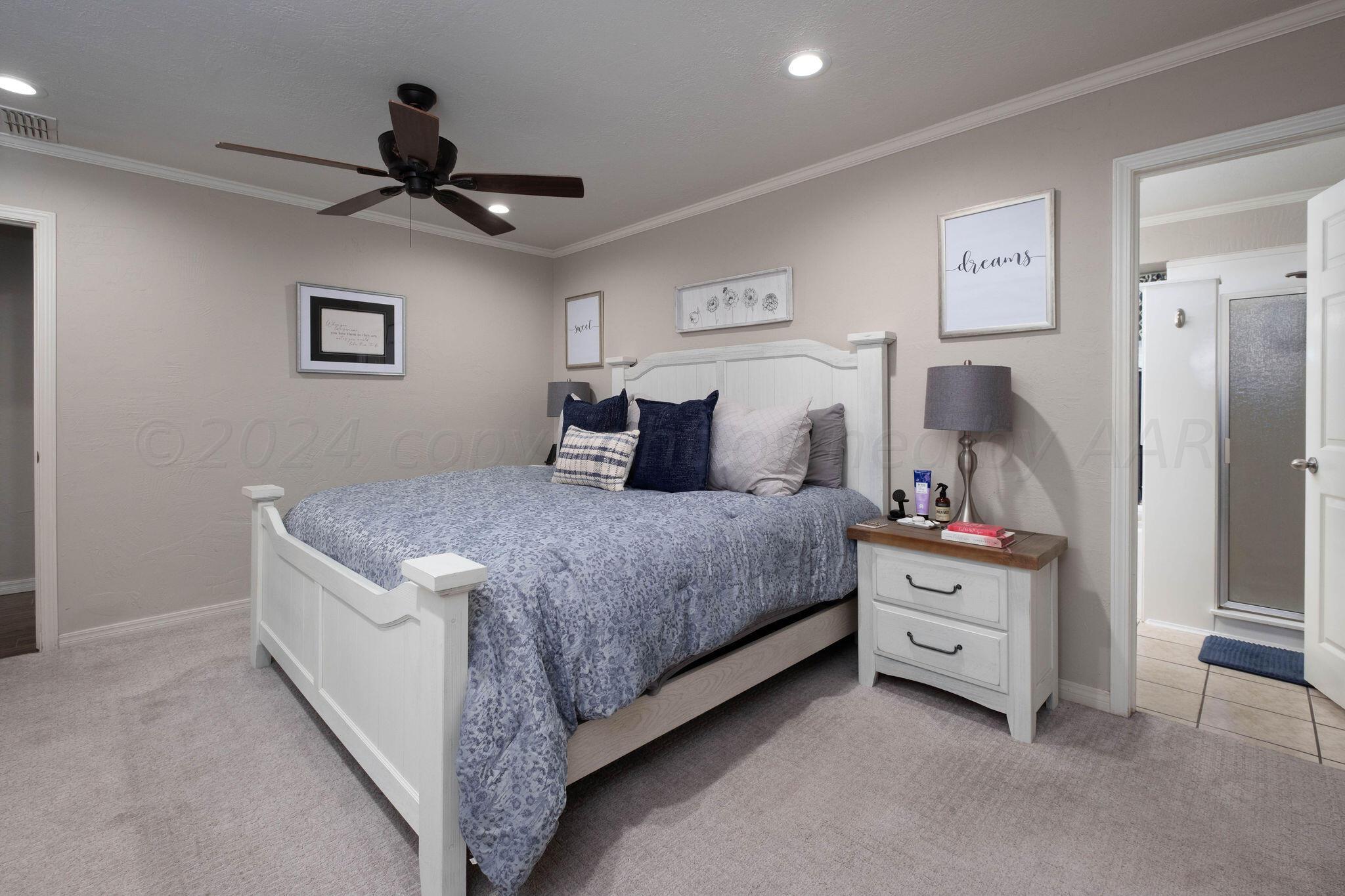 4400 Baltus Place Amarillo, TX 79121 - Photo 20 of 39 a bedroom with a bed and a chandelier