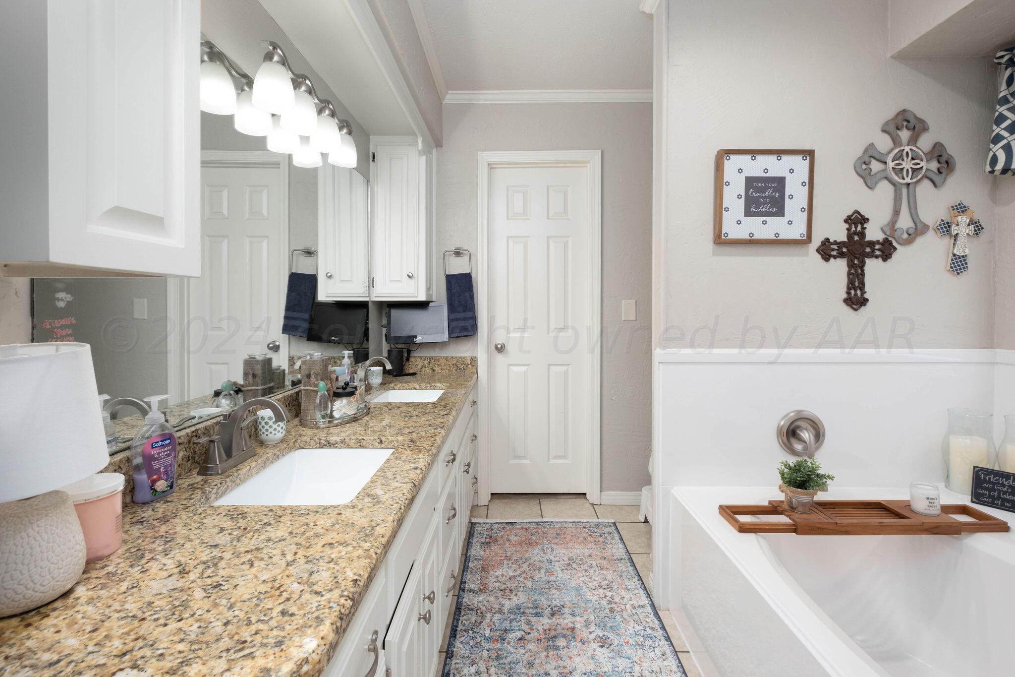 4400 Baltus Place Amarillo, TX 79121 - Photo 22 of 39 a bath room with a granite countertop sink and a mirror