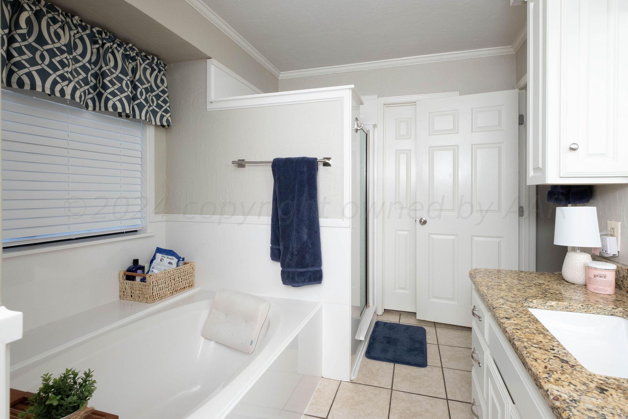 4400 Baltus Place Amarillo, TX 79121 - Photo 23 of 39 a bathroom with a tub shower and sink