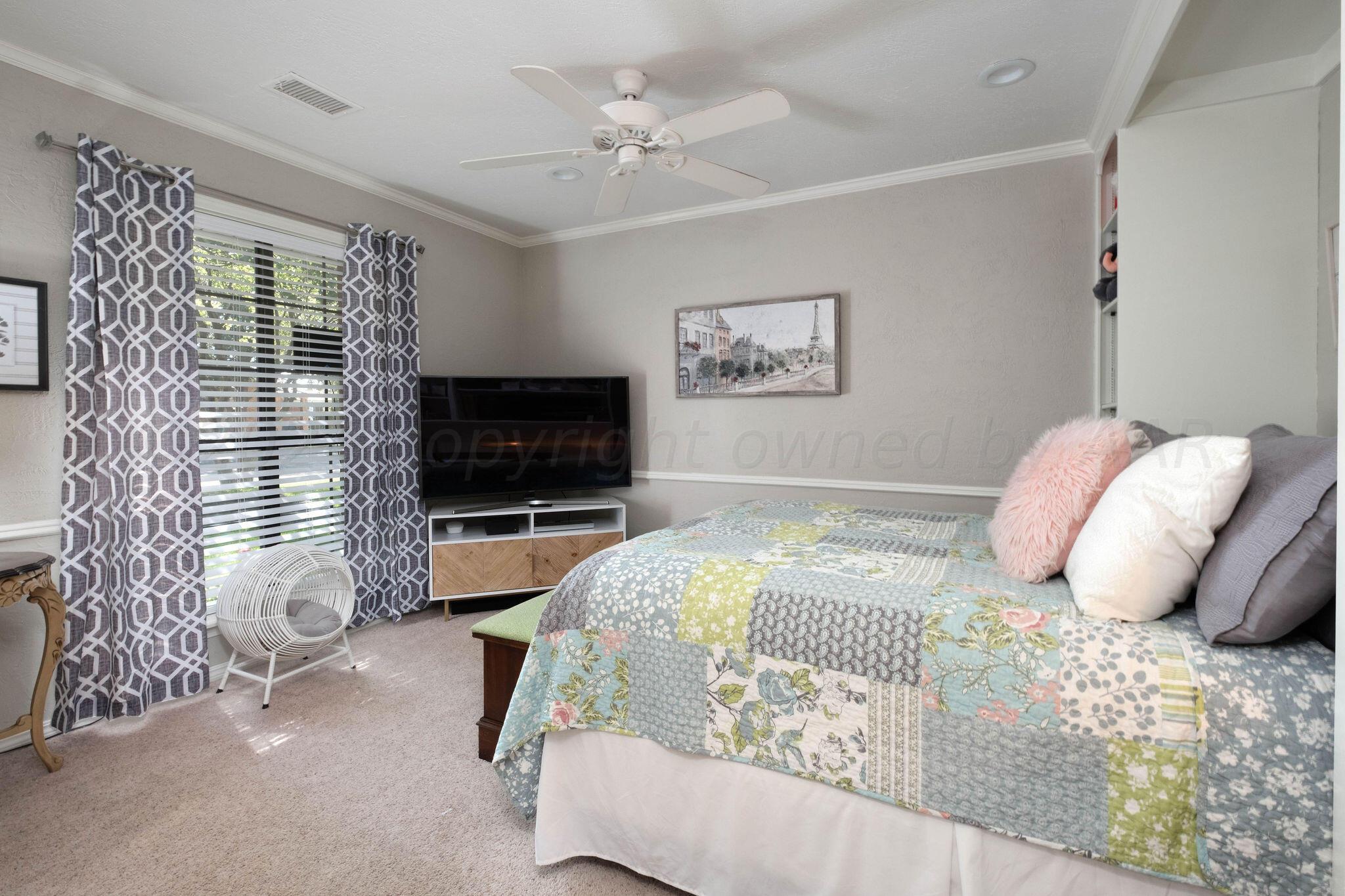 4400 Baltus Place Amarillo, TX 79121 - Photo 24 of 39 a bedroom with a bed and a flat screen tv