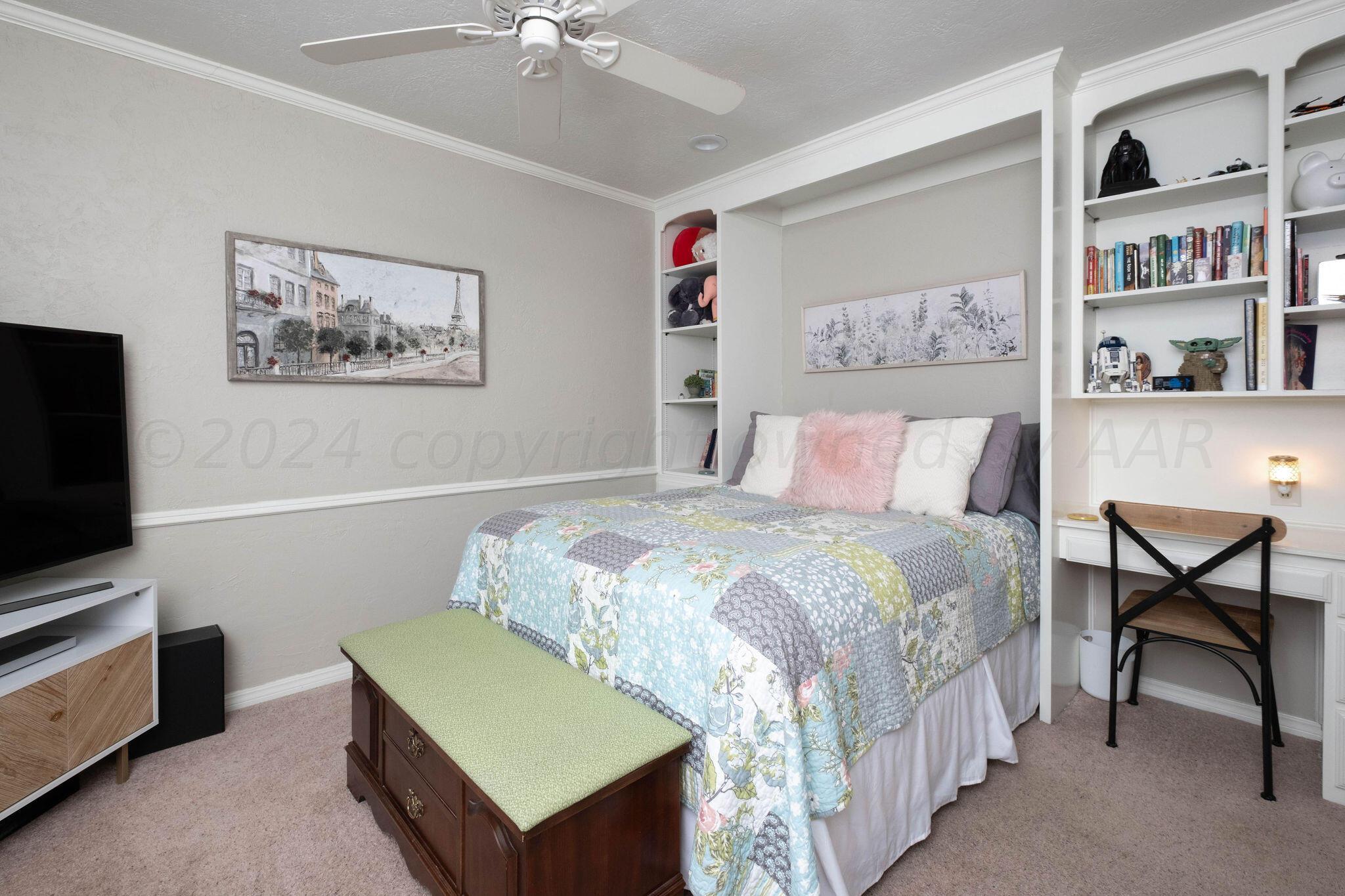 4400 Baltus Place Amarillo, TX 79121 - Photo 25 of 39 a bedroom with a bed a desk and painting on the wall
