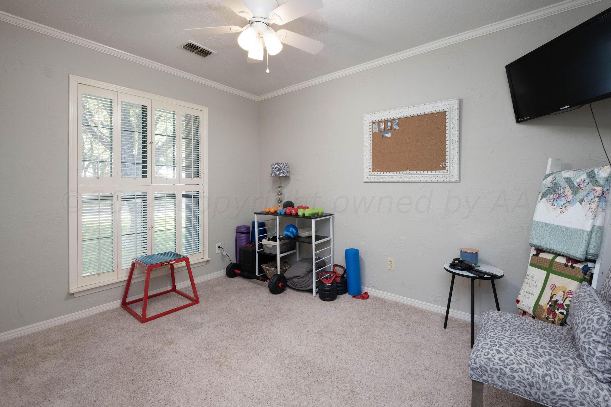 4400 Baltus Place Amarillo, TX 79121 - Photo 31 of 39 a living room with furniture a flat screen tv and a window