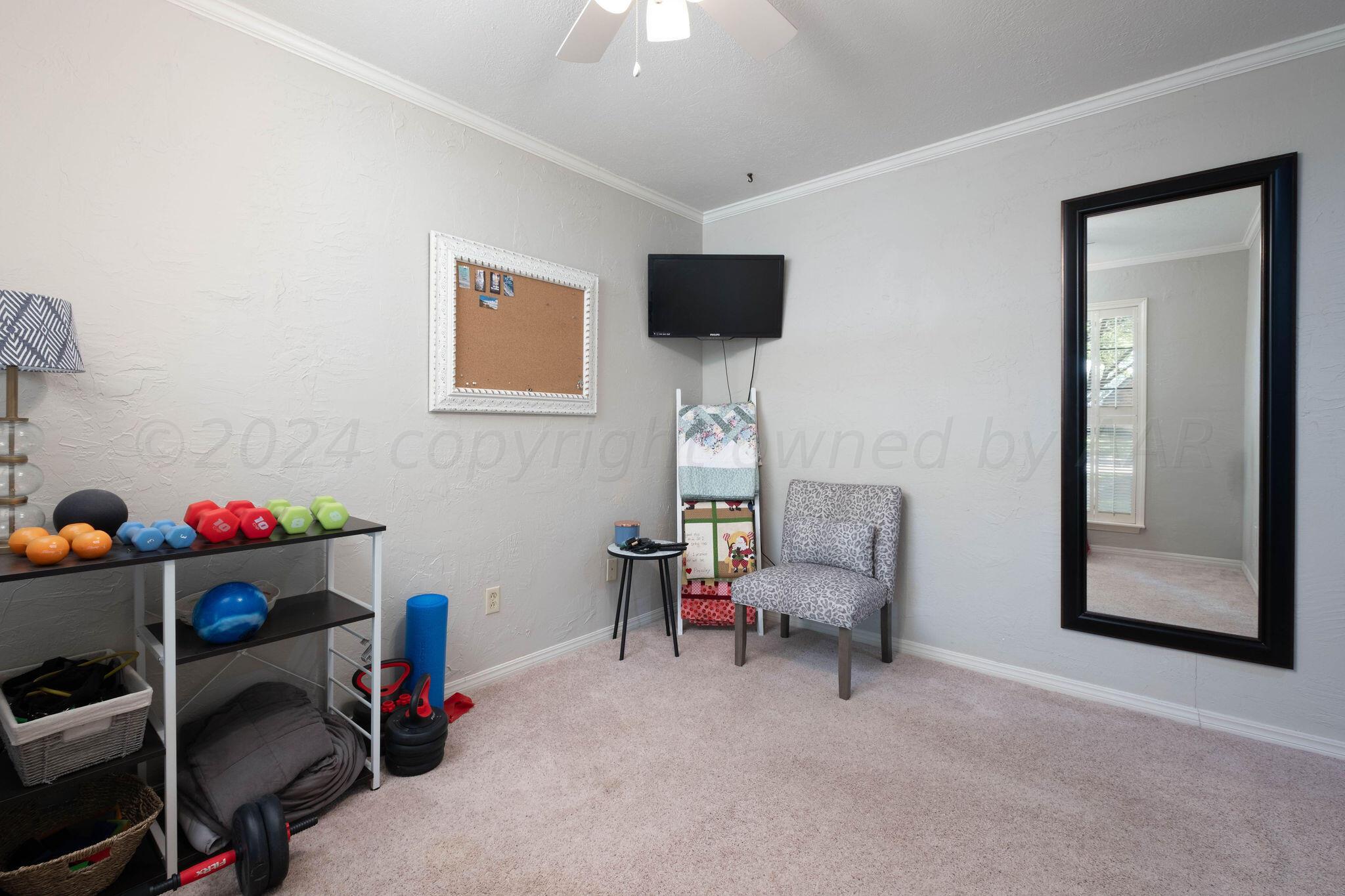 4400 Baltus Place Amarillo, TX 79121 - Photo 32 of 39 a living room with furniture and a flat screen tv