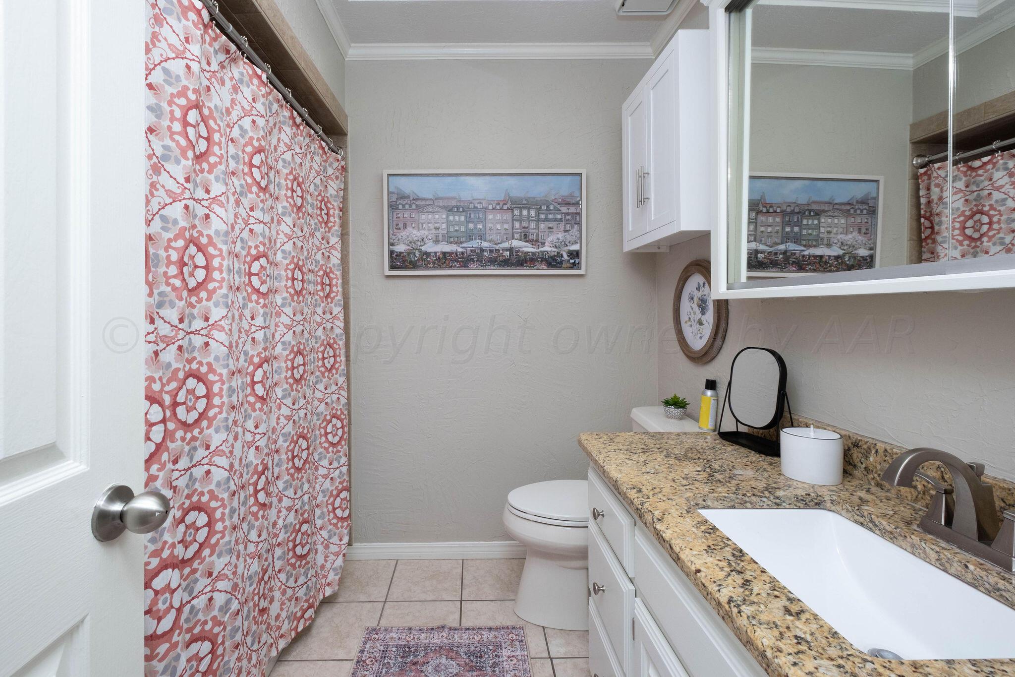 4400 Baltus Place Amarillo, TX 79121 - Photo 34 of 39 a bathroom with a granite countertop sink mirror vanity and toilet