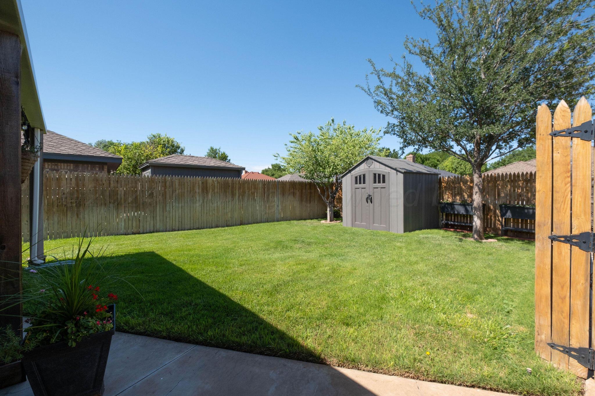 4400 Baltus Place Amarillo, TX 79121 - Photo 38 of 39 a backyard of a house with plants and tree