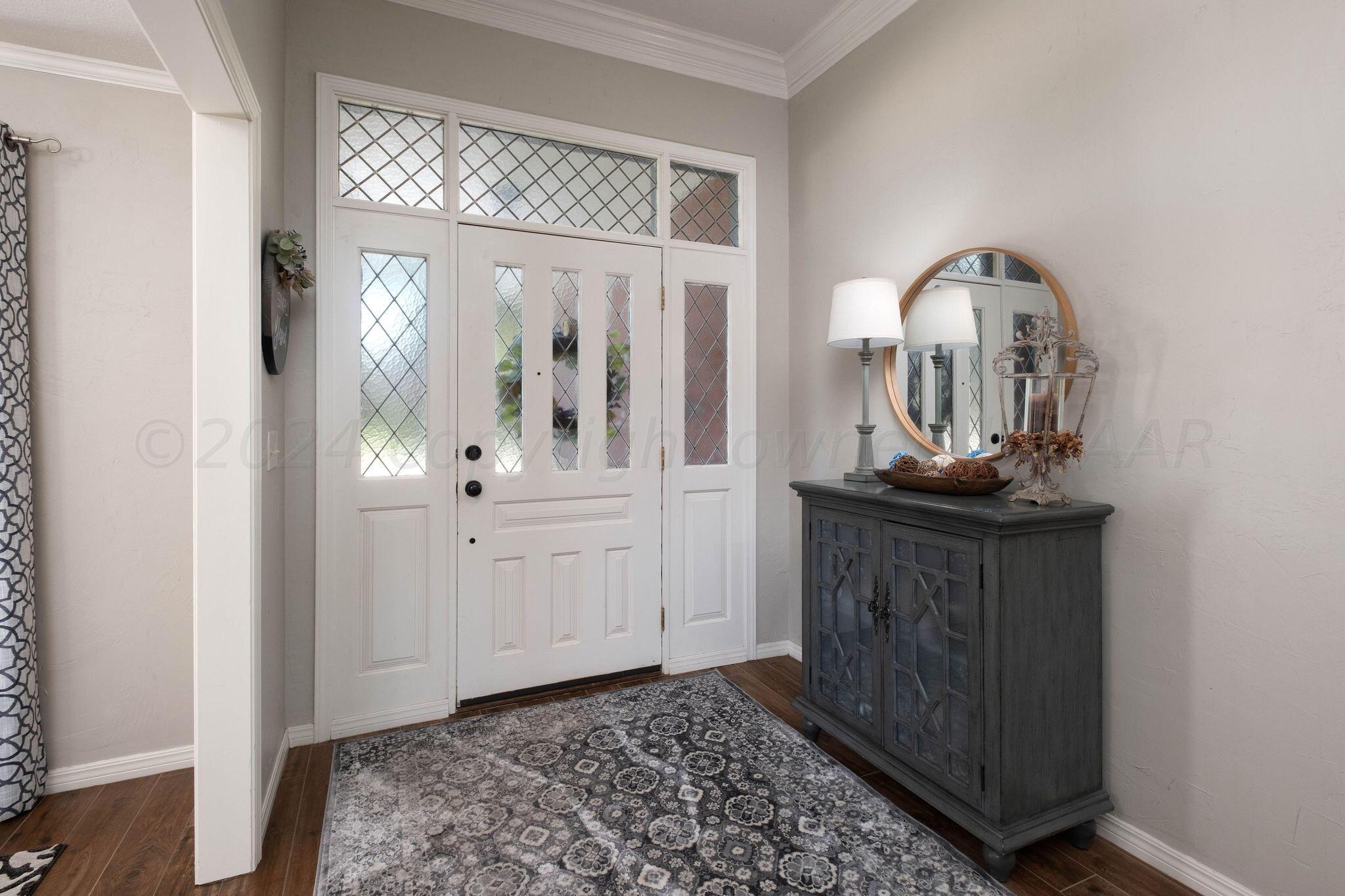 4400 Baltus Place Amarillo, TX 79121 - Photo 6 of 39 a view of a hallway with entryway wooden floor and front door