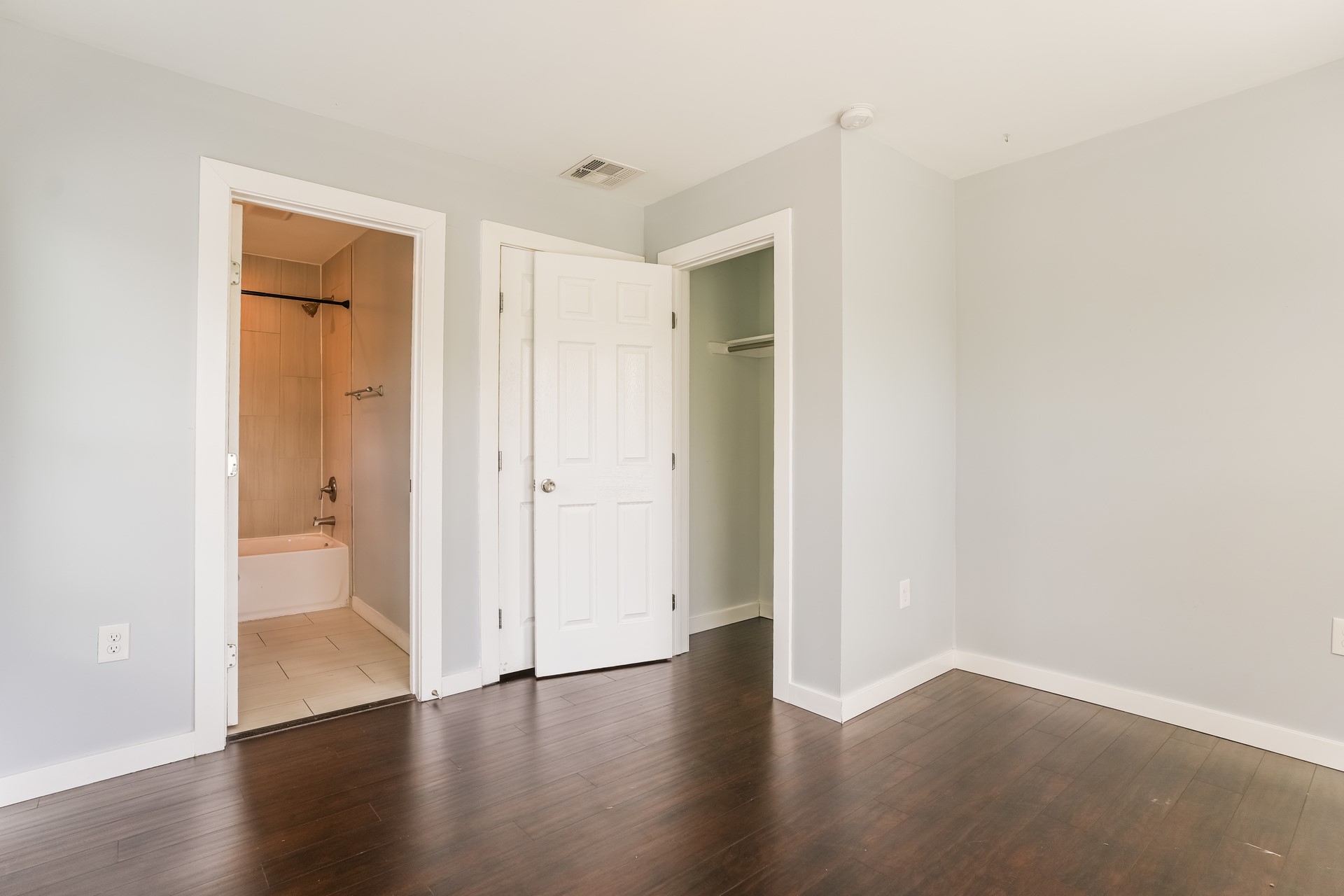 4801 Avenue H Austin, TX 78751 - Photo 4 of 16 Unfurnished bedroom with dark wood-style flooring, a closet, and ensuite bathroom