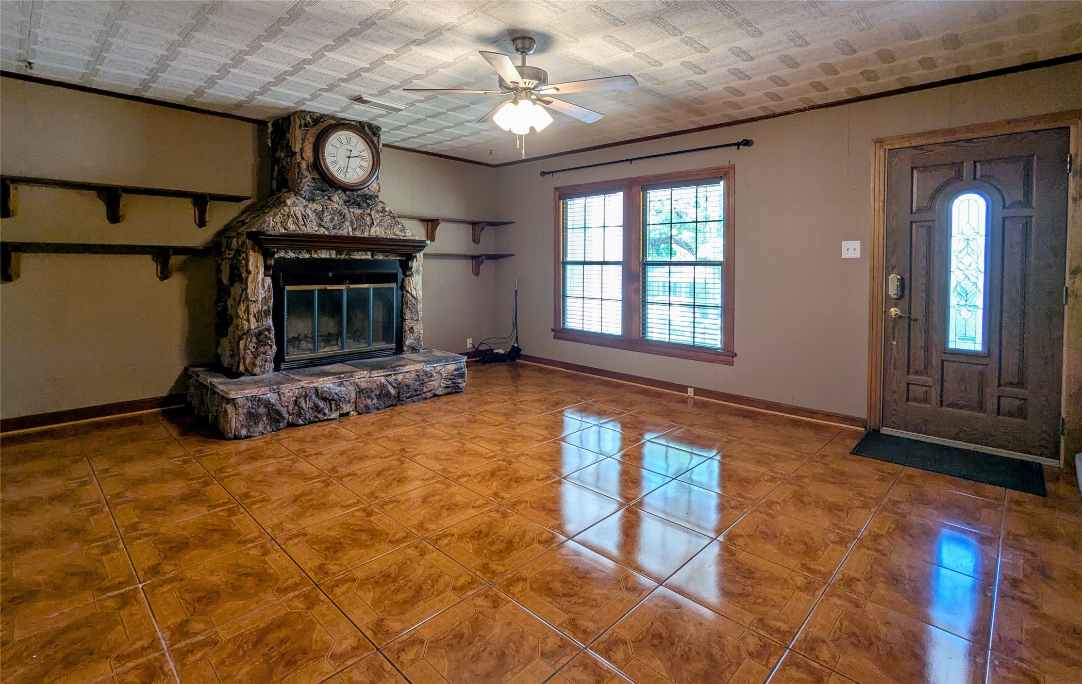 2654 Cos Street Liberty, TX 77575 - Photo 15 of 40 a view of an empty room with window chandelier fan and fire place