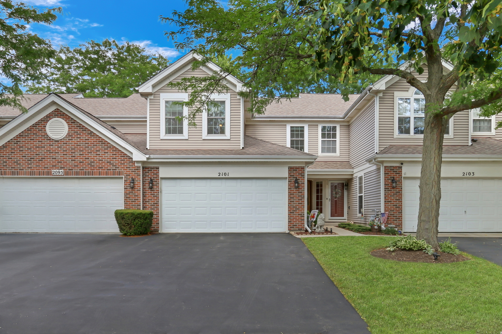 2101 Peach Tree Lane Algonquin, IL 60102 - Photo 1 of 24 a front view of a house with a yard and garage
