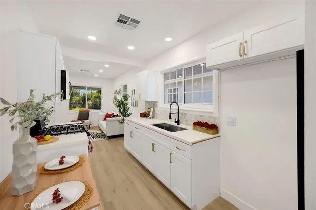 a kitchen with sink refrigerator and stove