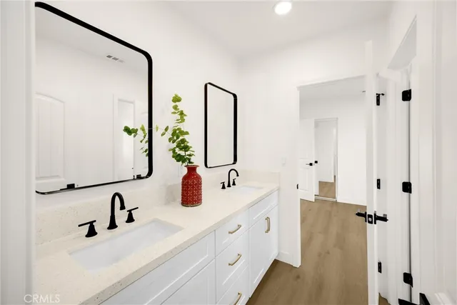 a bathroom with double vanity sink and mirror