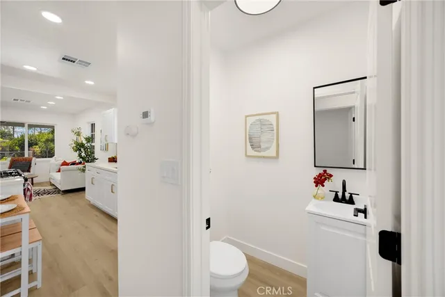 a bathroom with a toilet a sink and a mirror