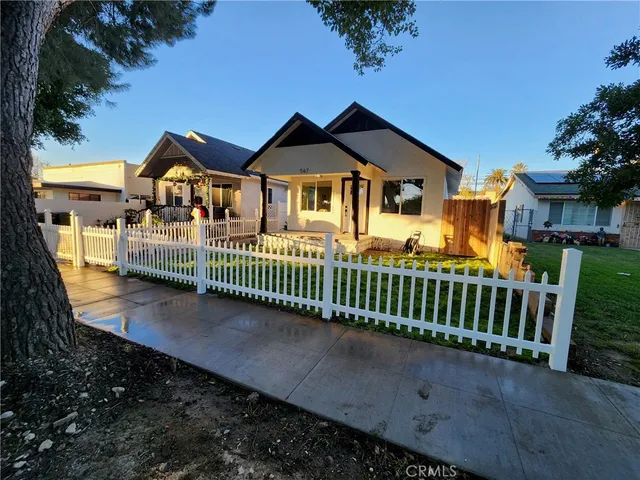a front view of a house with a garden