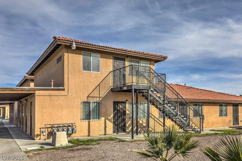 3127 North Walnut Road, Unit A Las Vegas, NV 89115 - Photo 2 of 12 A well-maintained stucco facade with a terracotta tile roof and exterior staircase offers multi-level living.