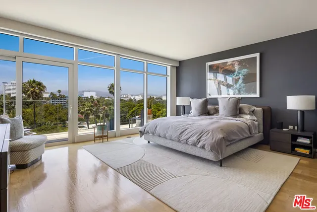 a bedroom with furniture and a flat screen tv