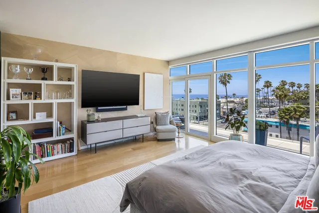 a spacious bedroom with a bed and a painting on the wall