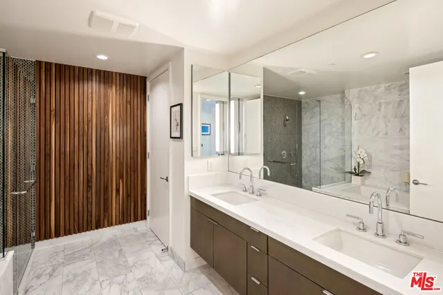 a bathroom with a shower sink and mirror