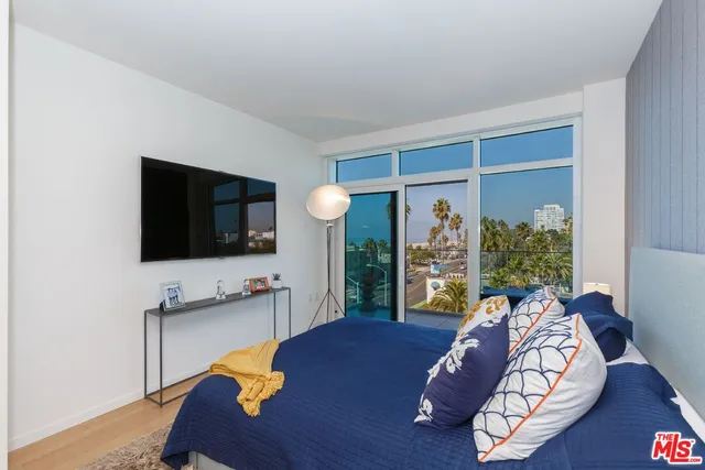 a bedroom with a bed and a lamp