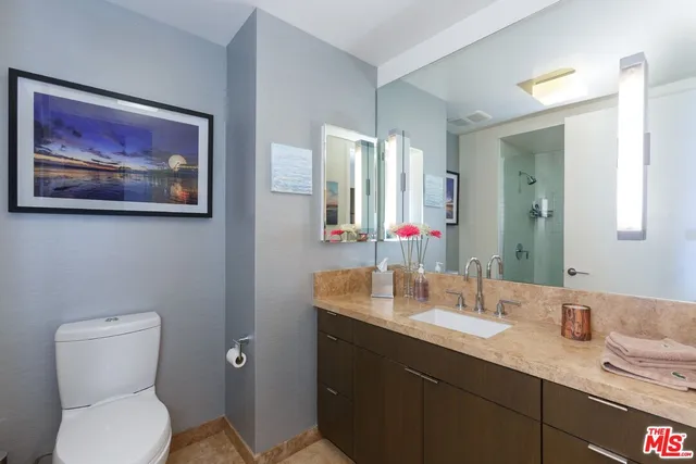 a spacious bedroom with a large window and a balcony