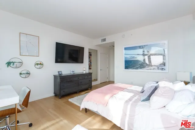 a view of a balcony with chairs and wooden fence