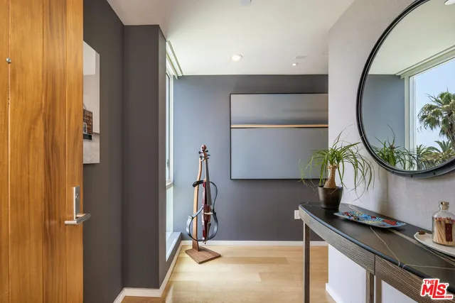 a living room with furniture a rug and kitchen view