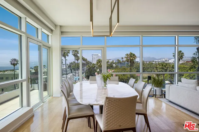 a kitchen with granite countertop a table chairs sink and cabinets