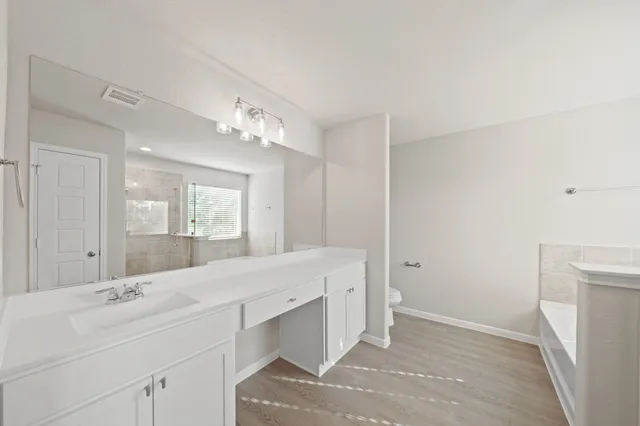 a bathroom with a double vanity sink mirror and