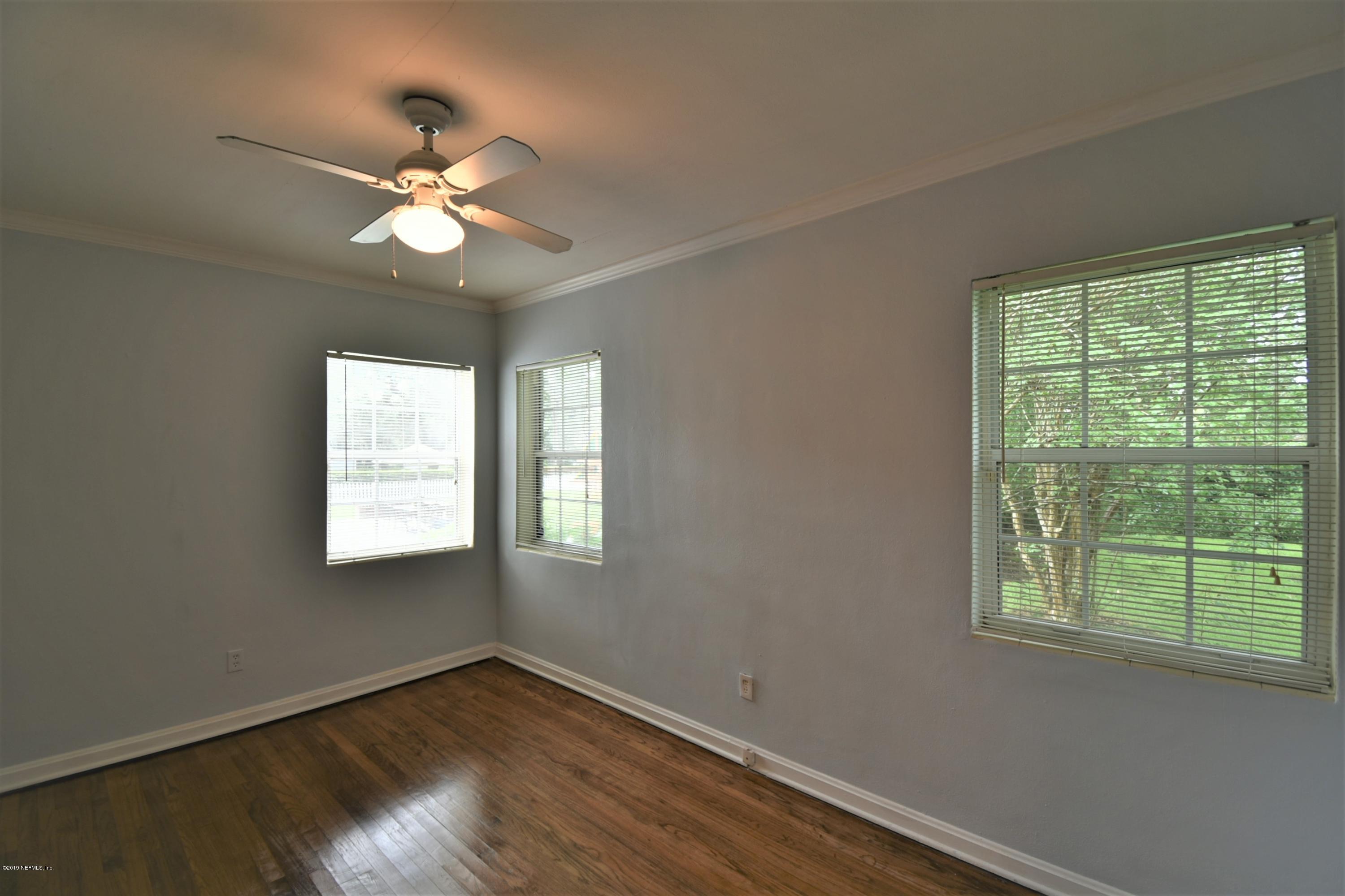 4253 Roma Boulevard Jacksonville, FL 32210 - Photo 11 of 17 a view of an empty room with wooden floor and a window