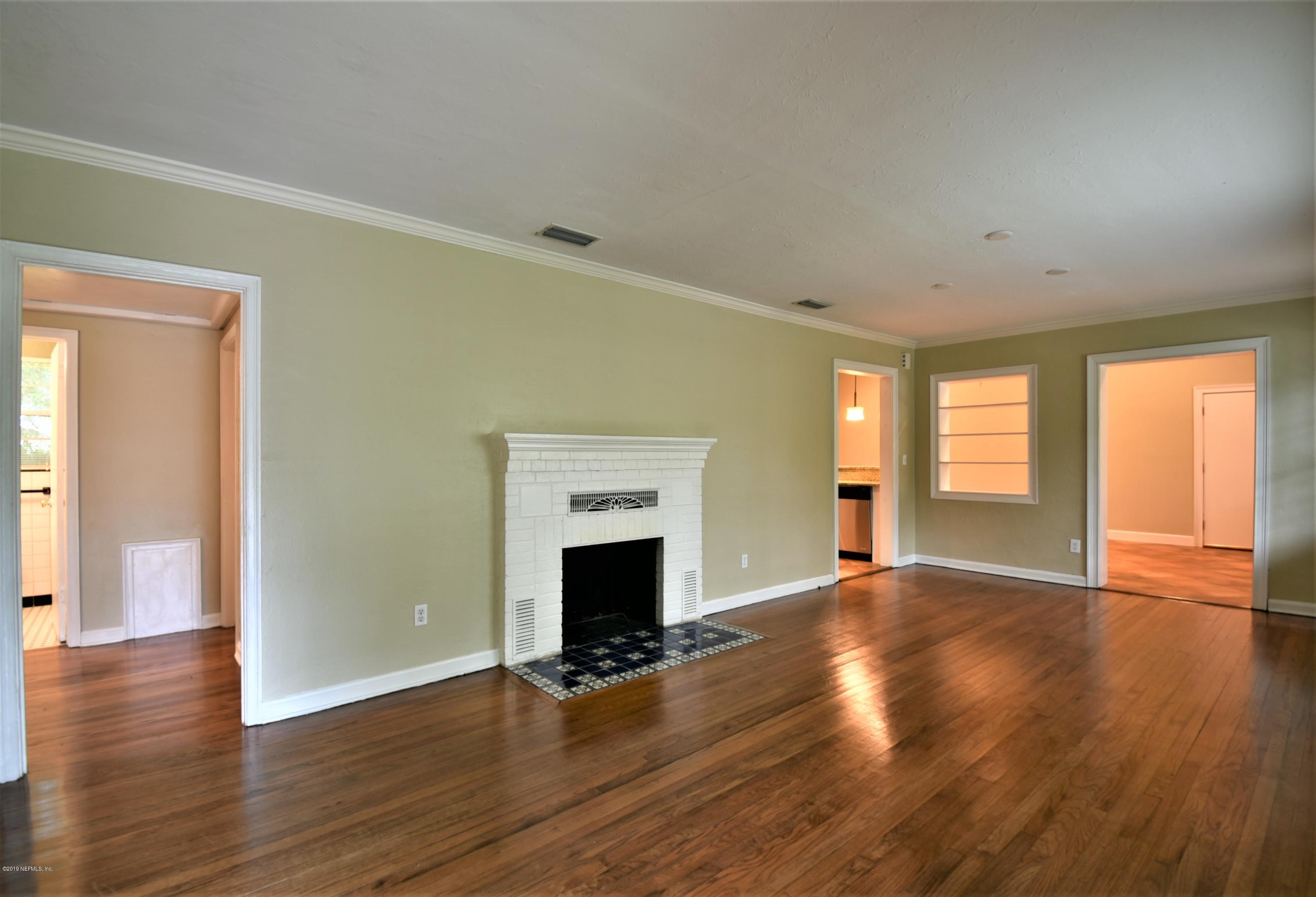4253 Roma Boulevard Jacksonville, FL 32210 - Photo 2 of 17 a view of an empty room with wooden floor and a window