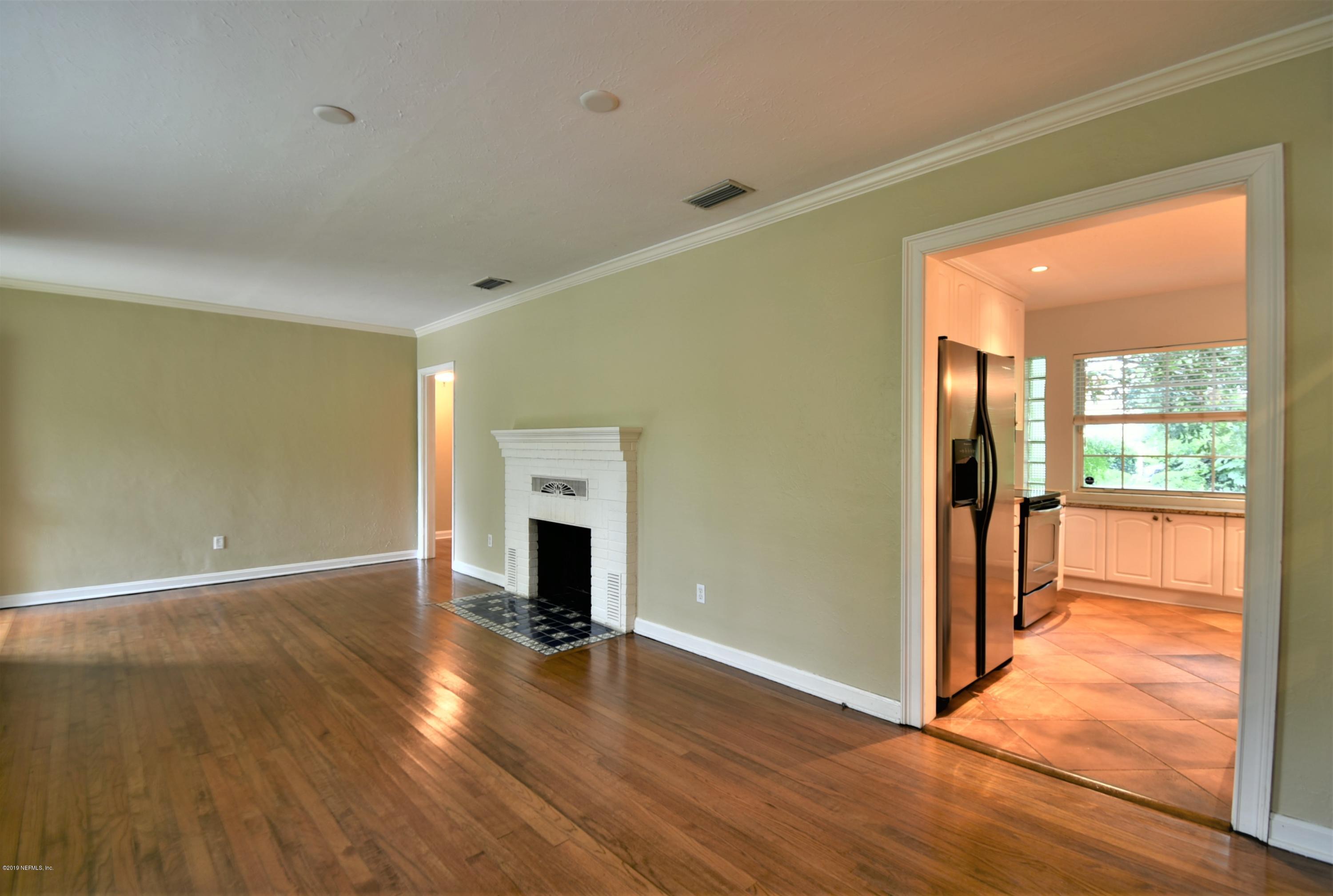 4253 Roma Boulevard Jacksonville, FL 32210 - Photo 3 of 17 a view of an empty room with wooden floor and a window