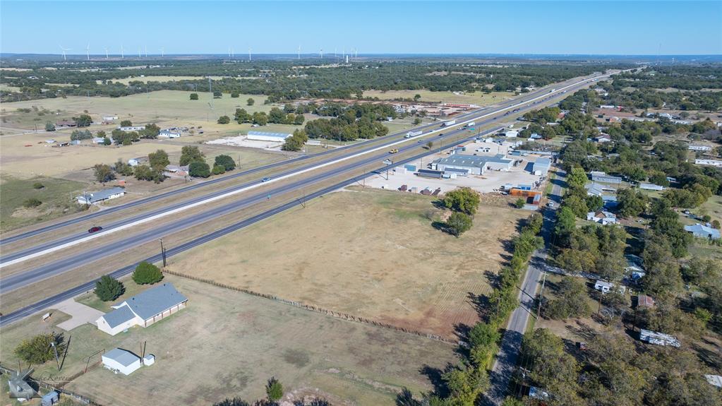 1823 South Access Road Clyde, TX 79510 - Photo 14 of 15 Aerial view of property and surrounding area featuring a tree filled landscape