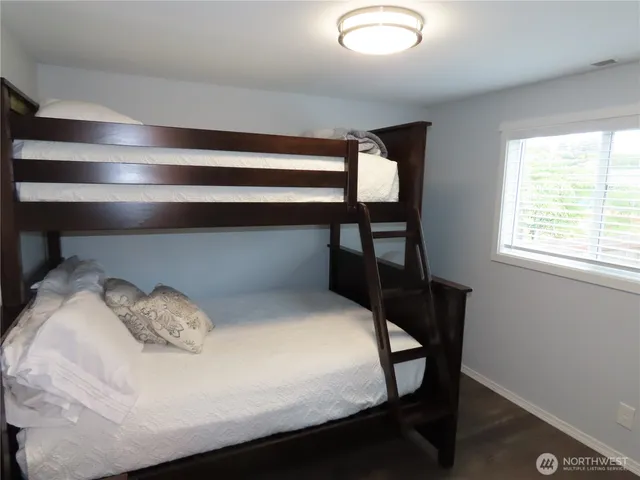 a bedroom with a bed chair and window