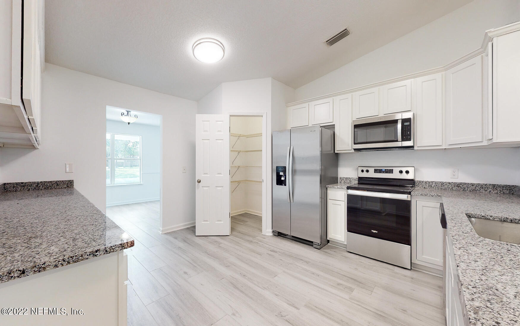 745 Ebb Tide Drive Fleming Island, FL 32003 - Photo 13 of 38 a kitchen with stainless steel appliances granite countertop a stove a refrigerator and a sink