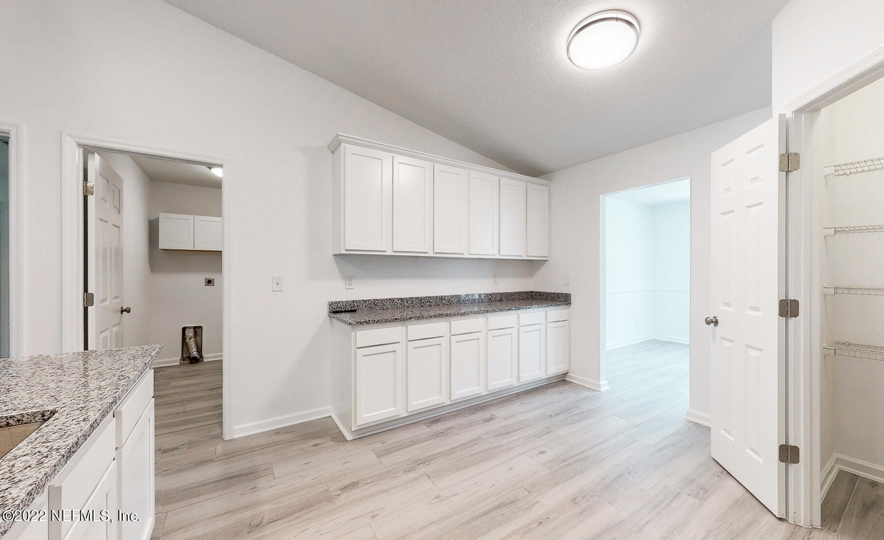 745 Ebb Tide Drive Fleming Island, FL 32003 - Photo 14 of 38 a kitchen with granite countertop white cabinets and white appliances