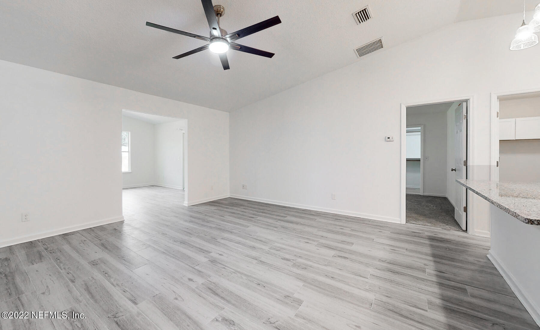 745 Ebb Tide Drive Fleming Island, FL 32003 - Photo 17 of 38 an empty room with wooden floor and windows