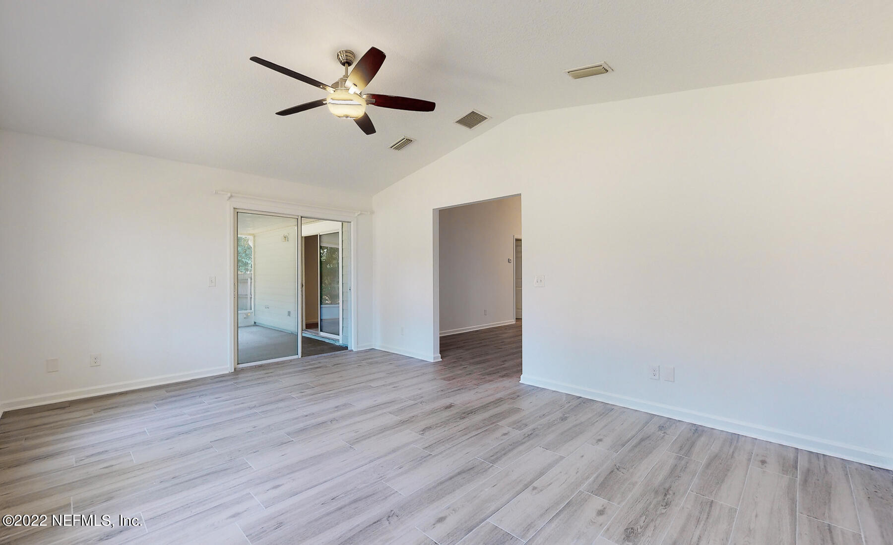 745 Ebb Tide Drive Fleming Island, FL 32003 - Photo 18 of 38 an empty room with wooden floor ceiling fan and windows