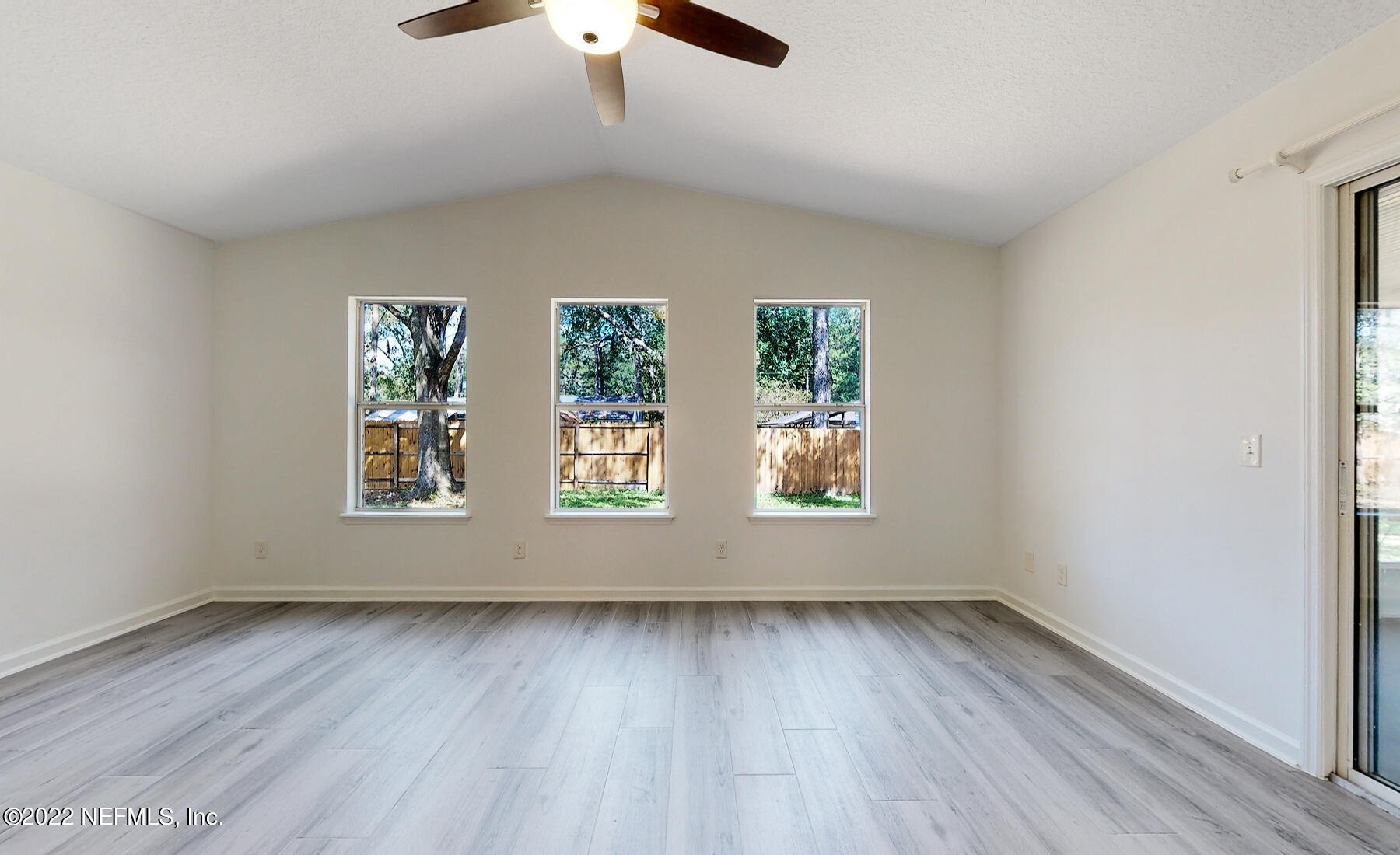745 Ebb Tide Drive Fleming Island, FL 32003 - Photo 19 of 38 an empty room with wooden floor and windows