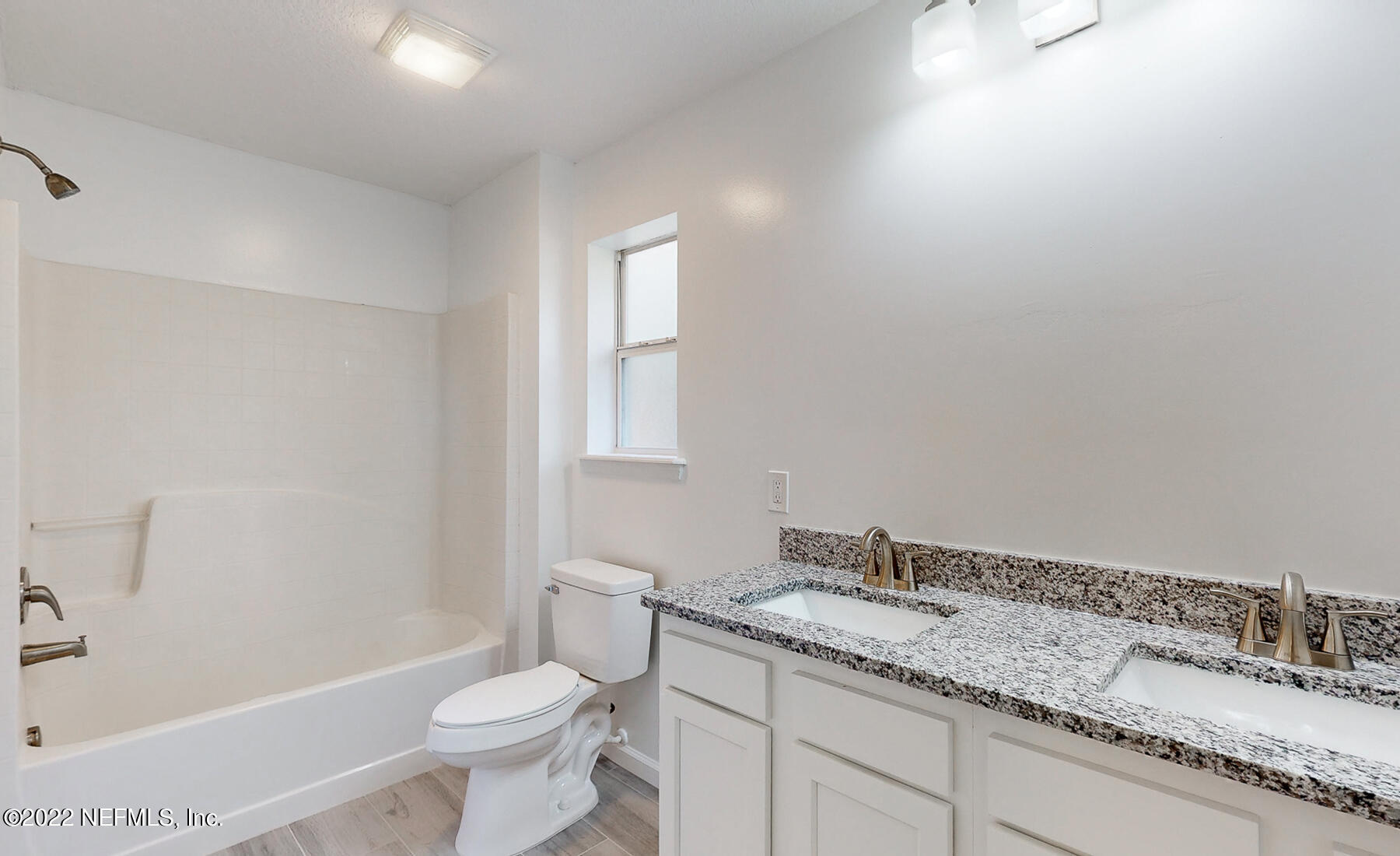 745 Ebb Tide Drive Fleming Island, FL 32003 - Photo 24 of 38 a bathroom with a granite countertop sink a toilet and a bathtub