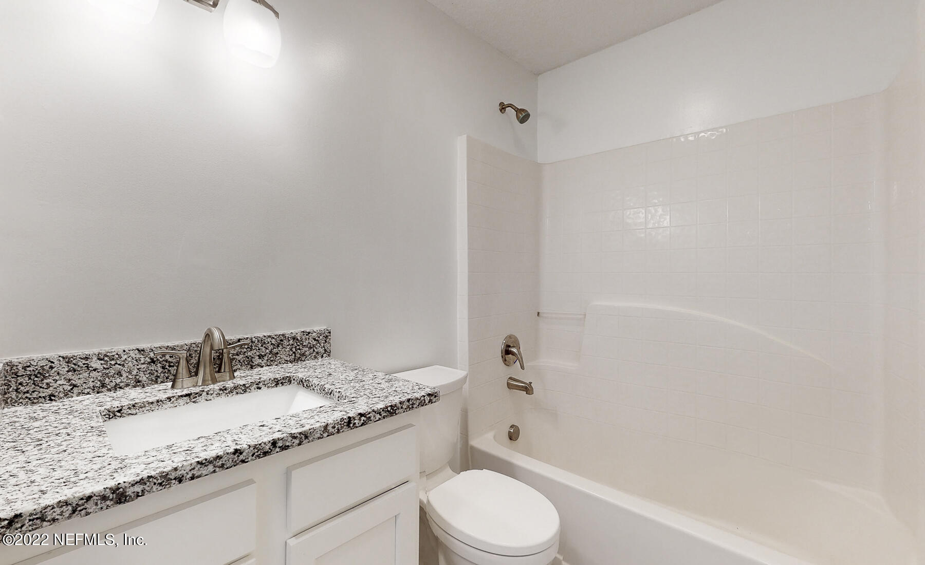 745 Ebb Tide Drive Fleming Island, FL 32003 - Photo 25 of 38 a bathroom with a granite countertop sink a toilet and shower