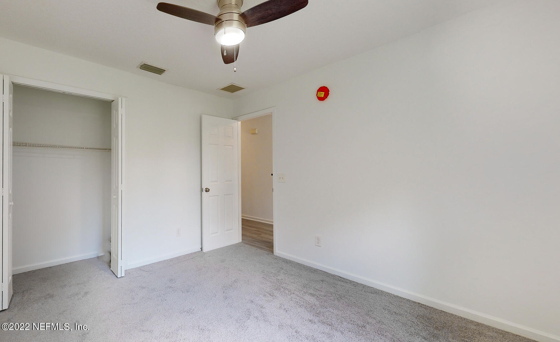 745 Ebb Tide Drive Fleming Island, FL 32003 - Photo 27 of 38 an empty room with a white cabinet and a chandelier fan