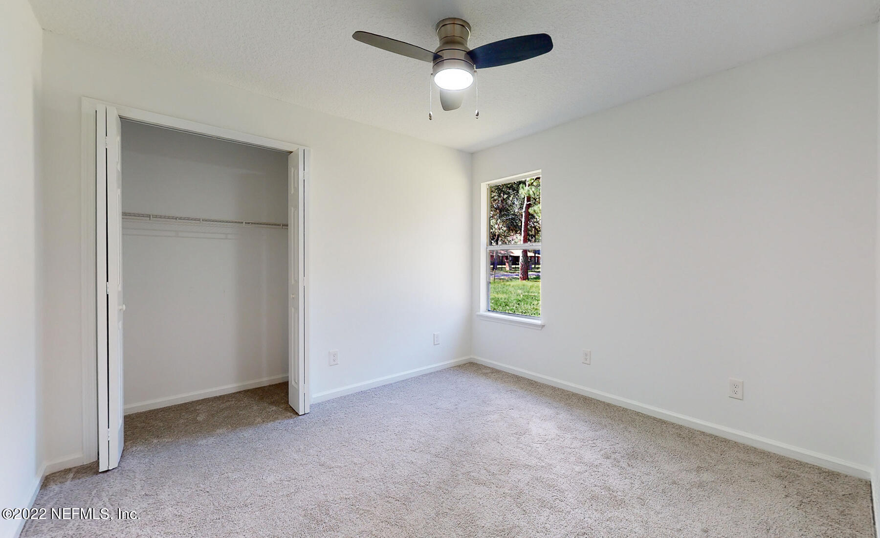 745 Ebb Tide Drive Fleming Island, FL 32003 - Photo 28 of 38 an empty room with windows and fan