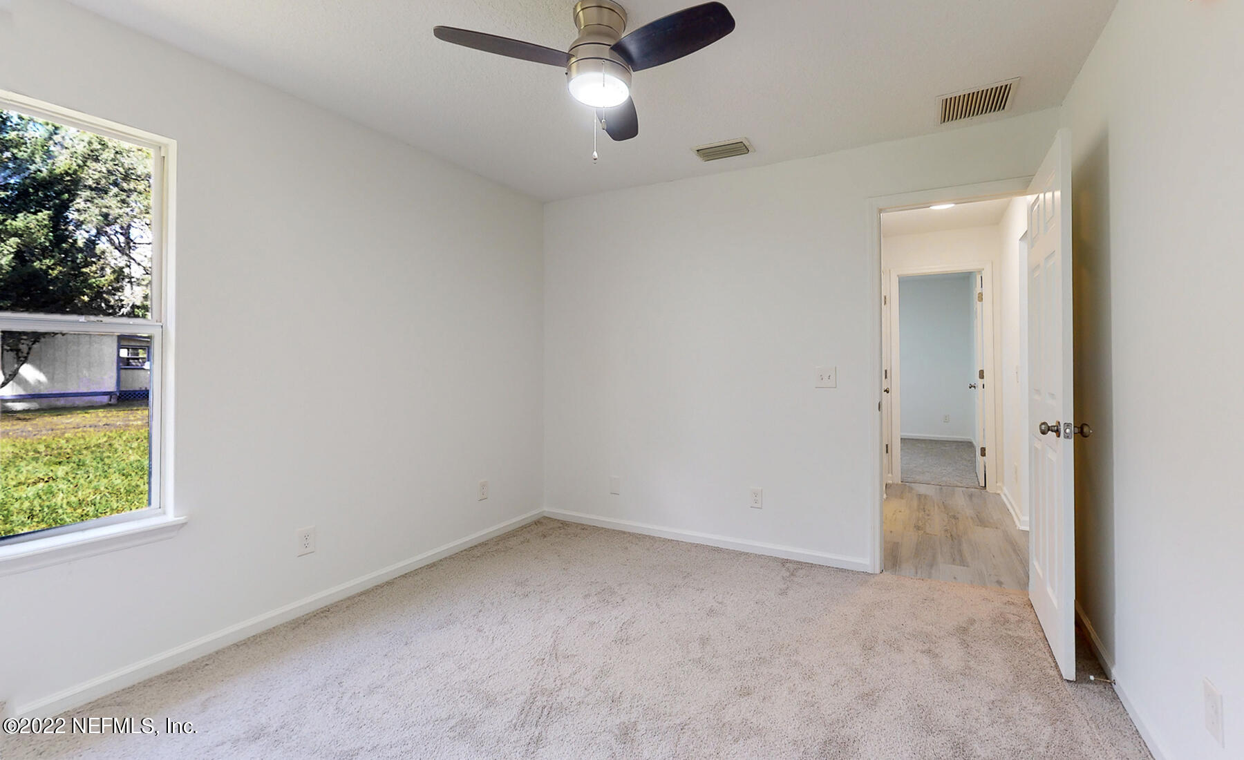 745 Ebb Tide Drive Fleming Island, FL 32003 - Photo 29 of 38 an empty room with a window and a ceiling fan
