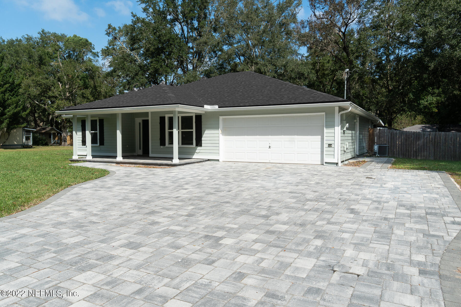 745 Ebb Tide Drive Fleming Island, FL 32003 - Photo 5 of 38 a front view of a house with a yard and trees