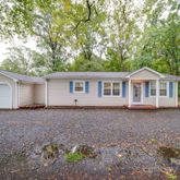 a view of house with a backyard